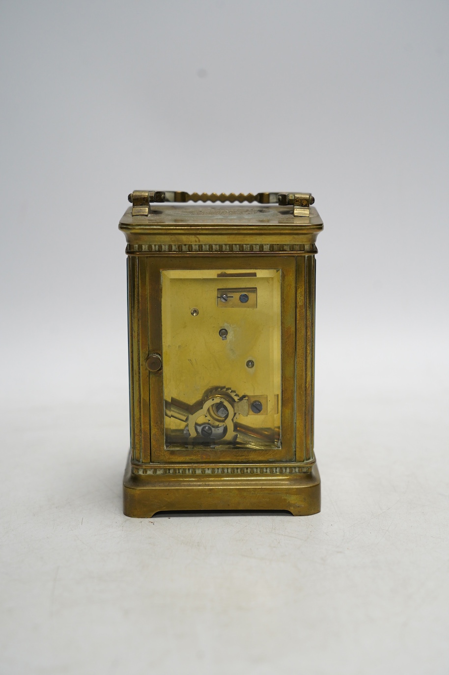 A brass cased carriage timepiece with enamel dial, with key, 15cm high. Condition - good, not tested